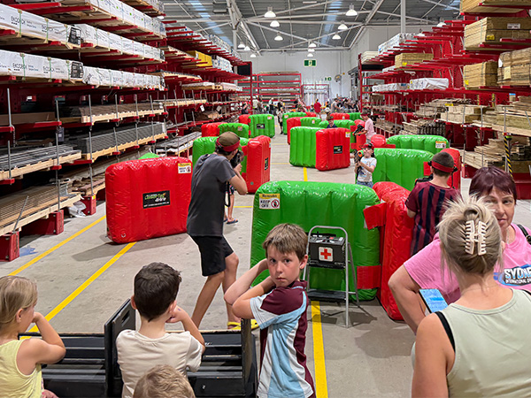 Players using inflatable obstacles as cover during a laser tag game