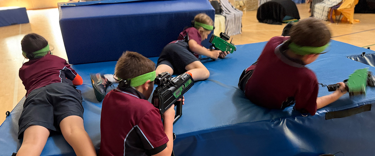 Children running a laser tag session at a school fete in NSW
