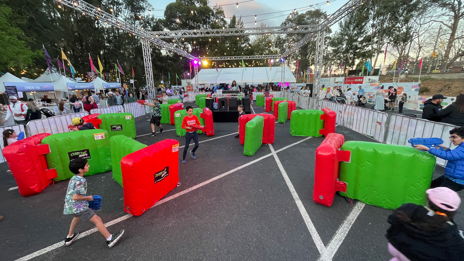 Children and adults playing laser tag at a school fete in NSW